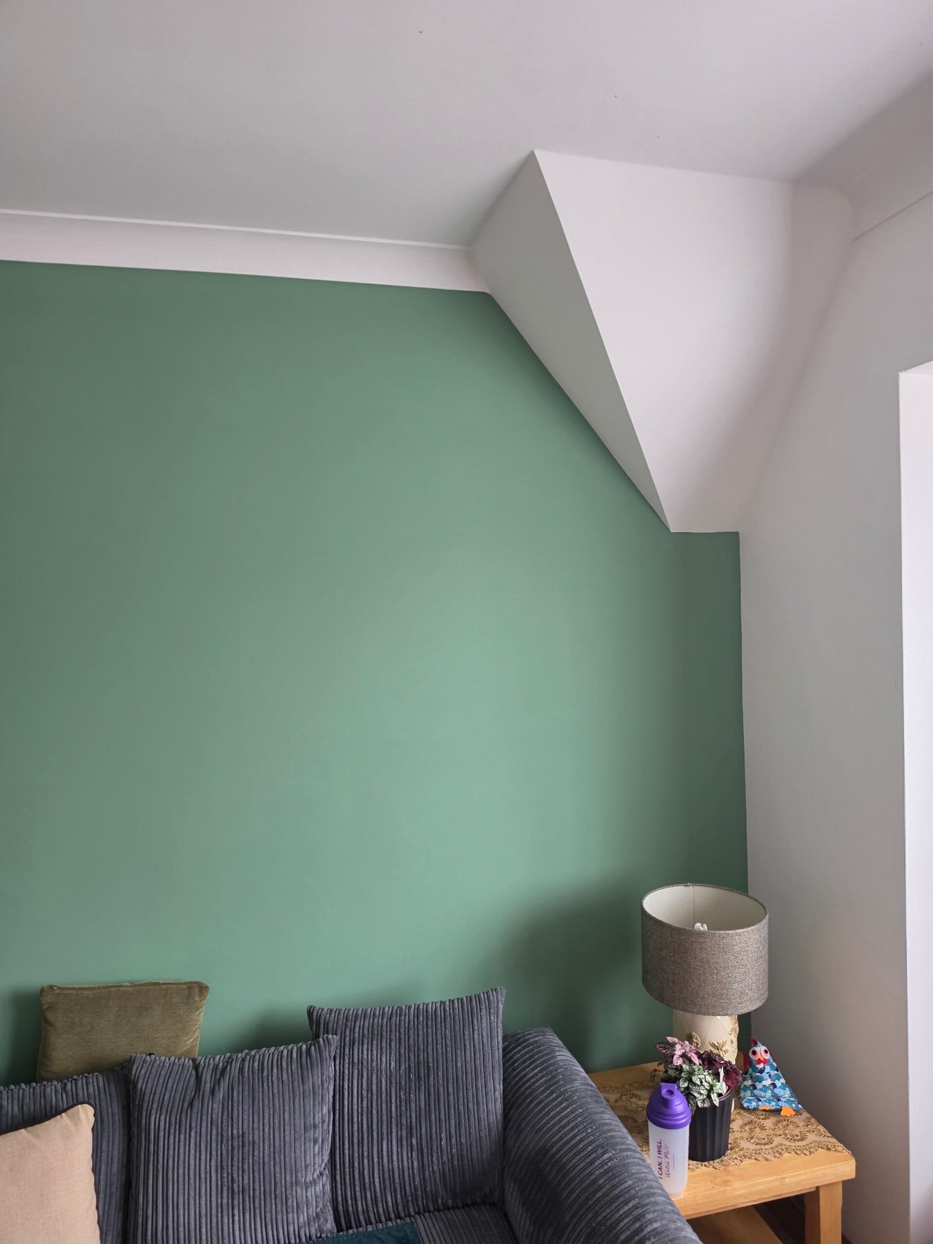 Bedroom redecorated with feature wall and clean cut-in lines